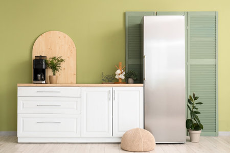 Interior of modern comfortable kitchen with white counter and refrigeratorの写真素材