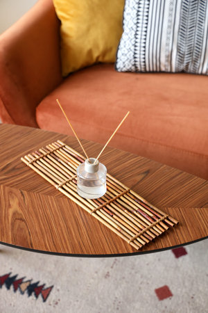 Aroma diffuser on wooden table in living room