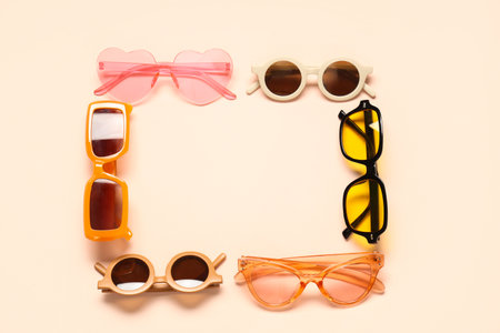 Frame made of sunglasses on pale pink backgroundの写真素材