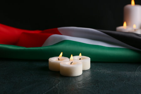 Flag of Palestine and burning candles on black backgroundの写真素材