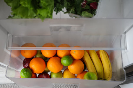 Open fridge with fresh fruits. Closeup