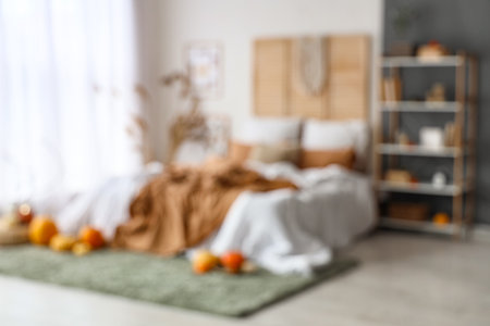 Blurred view of bedroom with shelf unit, pampas grass and pumpkinsの写真素材