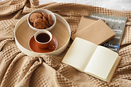 Tray with breakfast and books on bed, closeupの写真素材