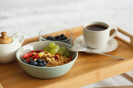 Tasty breakfast on tray in bedroom, closeupの写真素材
