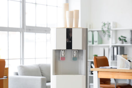 Modern water cooler in light officeの写真素材