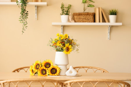 Dining table with wild flowers in roomの写真素材