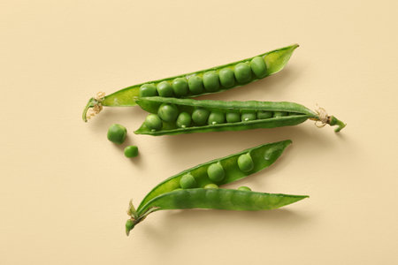 Green peas on beige backgroundの写真素材