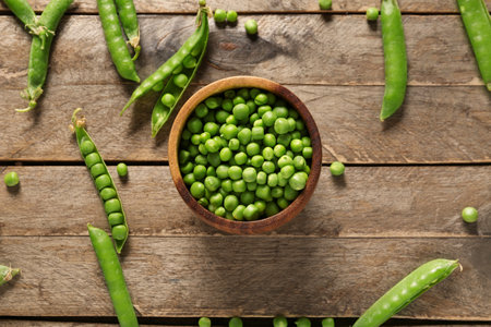 Bowl of green peas on wooden backgroundの写真素材