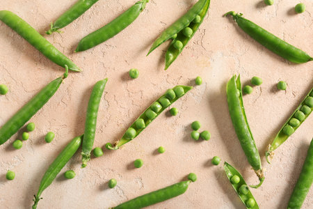 Green peas on beige background