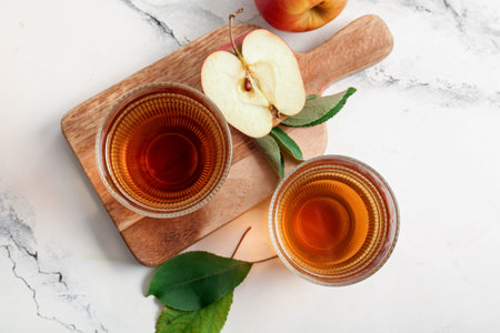 Glasses of fresh apple juice on white background