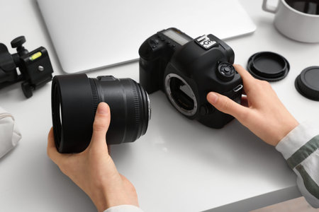 Female photographer with professional equipment at light table, closeup