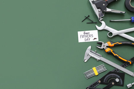 Tools and greeting card with text HAPPY FATHER'S DAY on green background