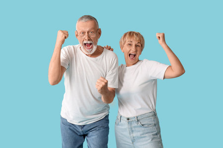 Happy mature couple on blue backgroundの写真素材