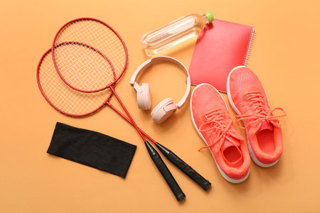 Sneakers, headphones and sports equipment on orange backgroundの写真素材