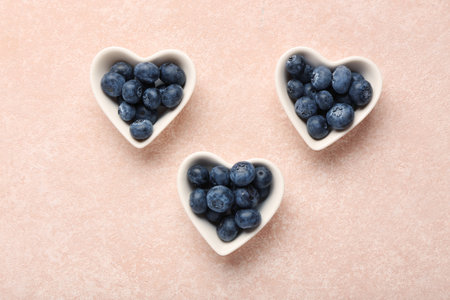 Bowls with sweet fresh blueberries on pink backgroundの写真素材