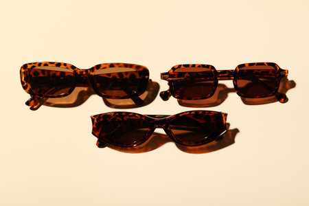 Stylish sunglasses on beige backgroundの写真素材