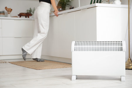 Electric convector heater in kitchen