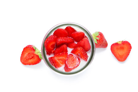 Glass of tasty yogurt with fresh strawberries on white backgroundの写真素材