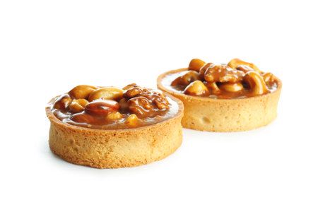 Tasty tarts with nuts and caramel isolated on white backgroundの写真素材