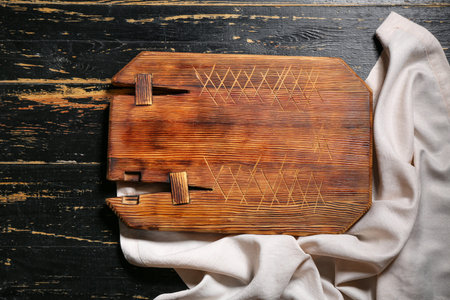 Wooden cutting board on black table