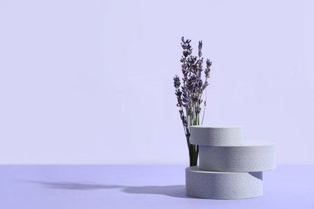 Decorative podiums with lavender flowers on lilac backgroundの写真素材