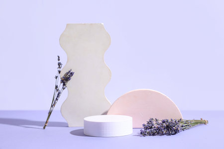 Decorative podiums with lavender flowers on lilac background