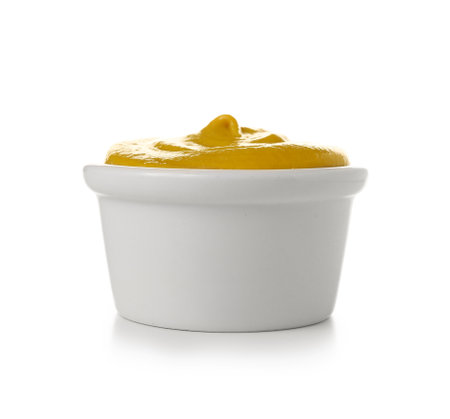 Plastic bowl with mustard isolated on white backgroundの写真素材