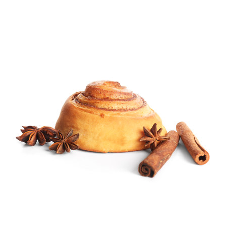 Sweet cinnamon roll and star anise on white backgroundの写真素材
