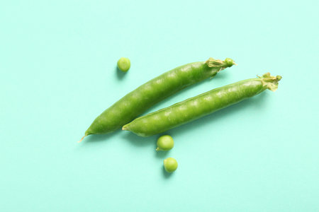 Green peas on turquoise background