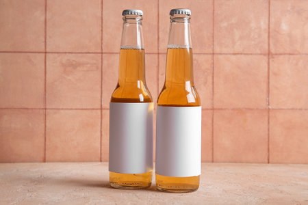 Bottles of cold beer on beige tableの写真素材