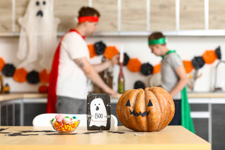 Halloween pumpkin with gift box and candies on table in kitchen, closeupの写真素材