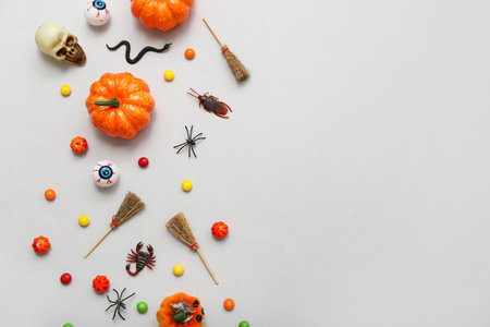 Composition with different decorations and candies for Halloween on gray backgroundの写真素材