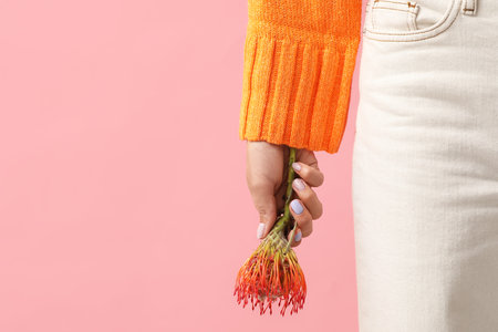 Woman with beautiful manicure and protea flower on pink background, closeupの写真素材