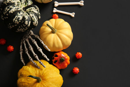 Composition with fresh pumpkins and decorations for Halloween on dark backgroundの写真素材