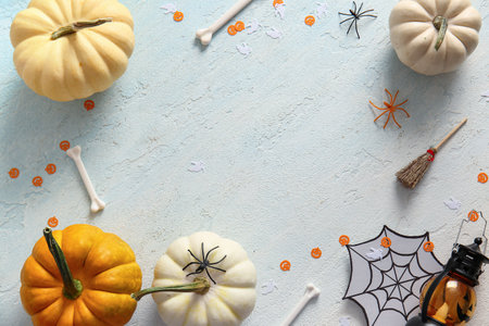 Frame made of pumpkins and decorations for Halloween on light backgroundの写真素材
