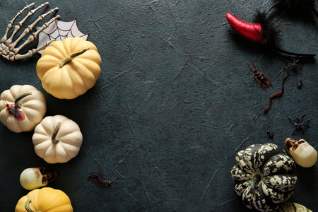Composition with fresh pumpkins and decorations for Halloween on dark color backgroundの写真素材