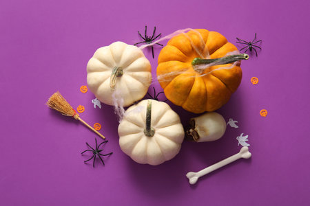 Composition with pumpkins and decorations for Halloween on purple backgroundの写真素材