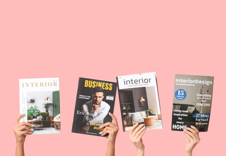 Female hands with different magazines on pink backgroundの写真素材