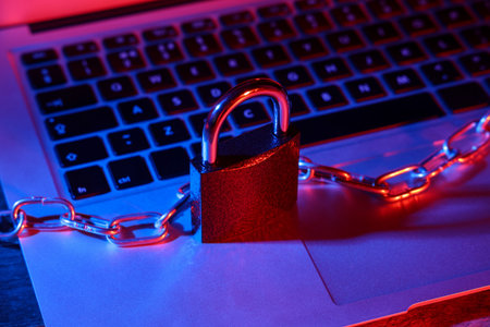 Padlock with chain on laptop, closeup. Cyber security concept