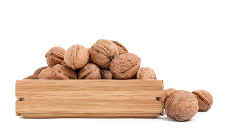 Wooden box with tasty walnuts on white backgroundの写真素材