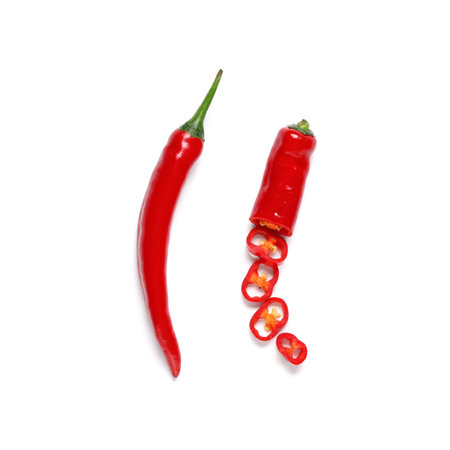 Red cut chili peppers on white background. Top view