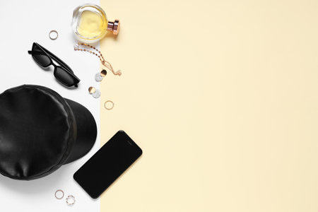 Stylish accessories with mobile phone, perfume and sunglasses on colorful background. Top viewの写真素材