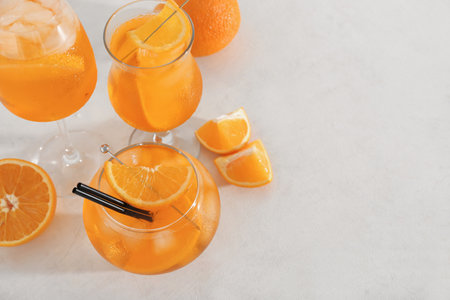 Glasses of Aperol spritz cocktail with oranges on white backgroundの写真素材