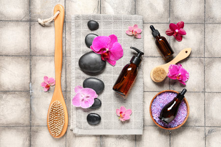 Composition with spa accessories, cosmetics and orchid flowers on grunge tile backgroundの写真素材