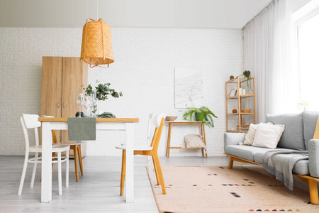 Interior of light room with dining table and sofaの写真素材