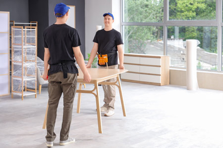 Loaders carrying table in stylish roomのeditorial素材