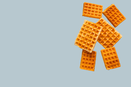 Falling waffles on gray background