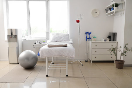 Interior of hospital ward with bed, drawers and coolerの写真素材