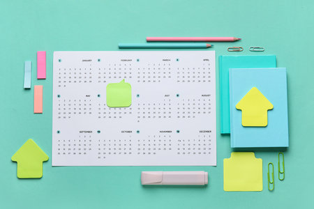 Calendar with office stationery on turquoise backgroundの写真素材