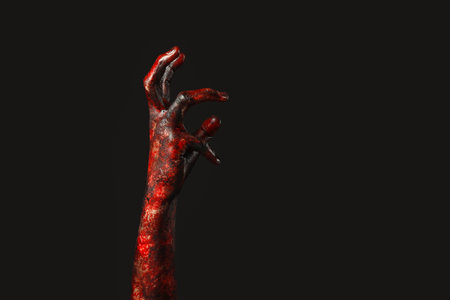 Hand of zombie on black background. Halloween celebration